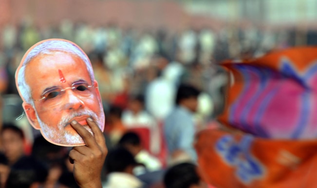 A-Narendra-Modi-supporter-holds-a-mask-of-the-BJP