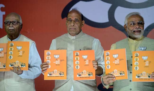 BJP prime ministerial candidate Narendra Modi with party president Rajnath Singh and senior leader Lal Krishna Advani at the BJP manifesto release. AFP