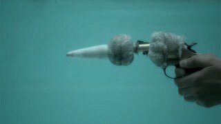 Shooting a gun underwater has never looked this cool Shooting a gun underwater has never looked this cool