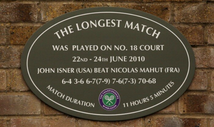 A view of the plaque hanging outside court 18 stating 'The Longest Match' in honor of the match played by John Isner and Nicolas Mahut