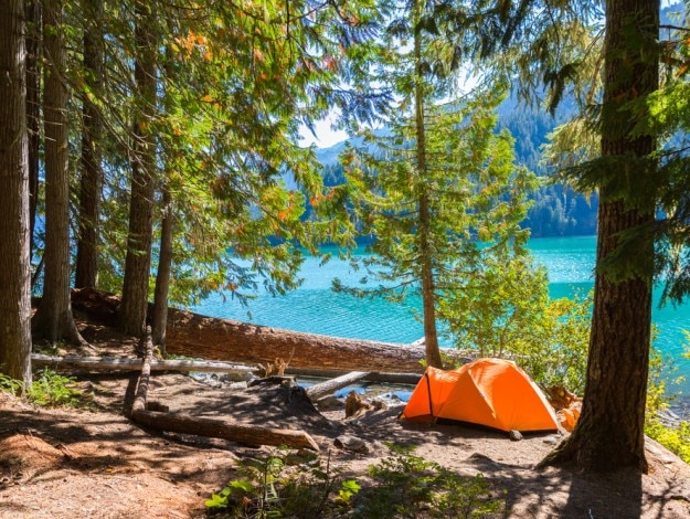 Majestic mountain Cheakamus turquoise water lake in Canada with campsite and orange tent
