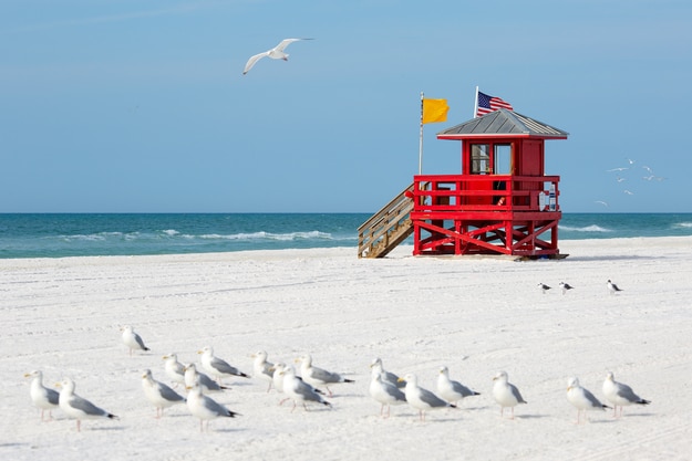 Red wooden lifeguard hut on an empty morning at Siesta Beach, Florida