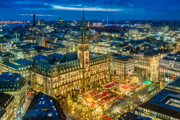 Historic Christmas market on Rathausmarkt in downtown Hamburg, Germany in the evening. Woodcarvers, gingerbread bakers, ceramics artists, silversmiths and many others welcome you