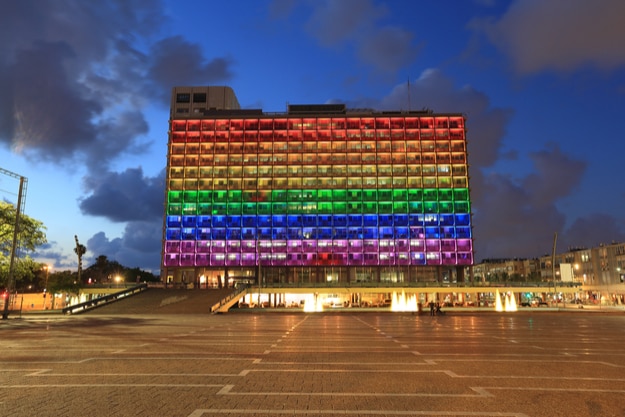 Rainbow flag lighting over Tel Aviv city hall building for pride month