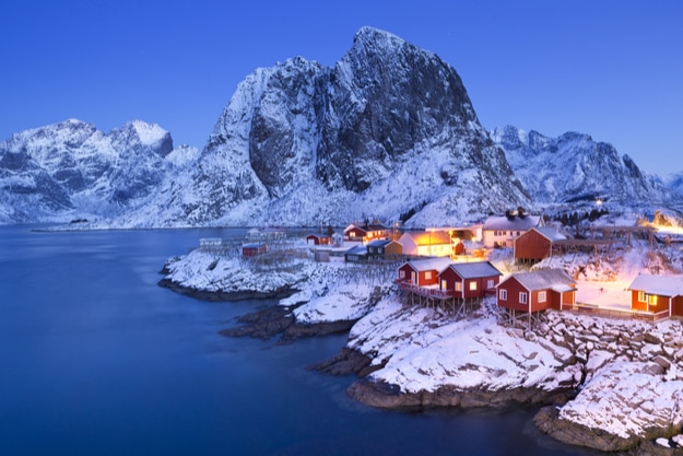 Traditional Norwegian fisherman's cabins, rorbuer, on the island of Hamnoy, Reine on the Lofoten in northern Norway. Photographed at dawn in winter
