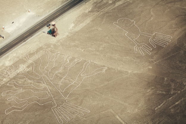 Tree (Arbol) and Hands (Manos) lines in Nazca desert and observation tower near the road