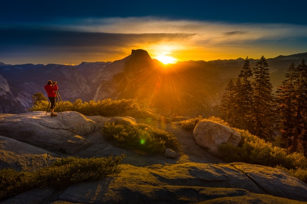 Yosemite National Park Woman Photographer taking pictures at Sunrise from the Glacier Point