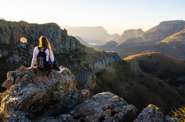 A girl sitting on a rock at Lowveld view in Blyde River Canyon Nature Reserve (Motlatse Canyon Provincial Nature Reserve) in Mpumalanga, Republic South Africa