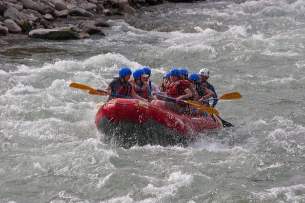 A group of people rafting in the waters of the Canete river in Lunahuana, Lima, Peru