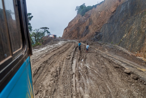 Bus on a muddy road in Yungas mountains, Bolivia