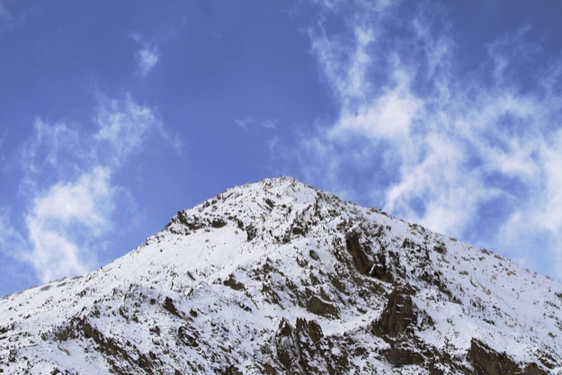 Himalayan mountain top and blue sky with clouds in Ladakh, India. Hemis High Altitude National Park
