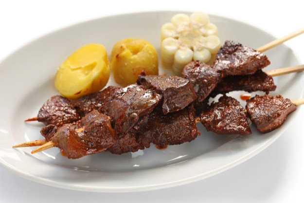 anticuchos, Peruvian cuisine, grilled skewered beef heart meat with boiled potato and white corn