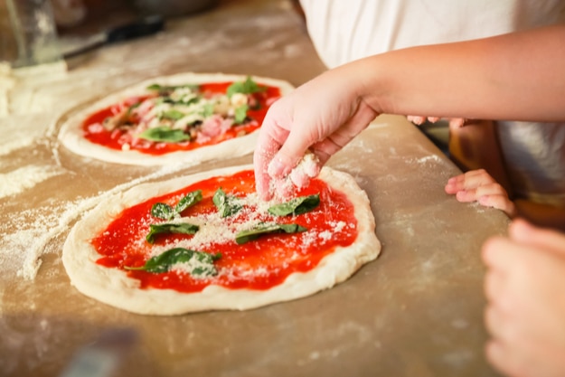 Preparing Pizza Margherita, the archetype of Neapolitan pizza