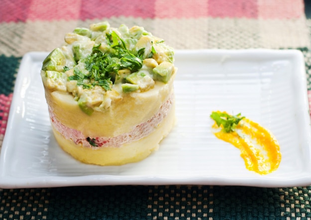 Authentic peruvian "Causa", made with mashed potatoes, tuna, peruvian "aji amarillo" pepper, tomato, onions, avocado and fresh coriander