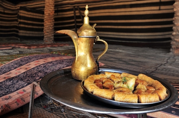 Arabic coffee jug and cookies served in Bedouin tent in the middle east