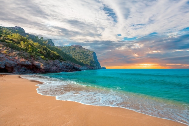 Beach of Cleopatra with sea and rocks of Alanya peninsula, Antalya, Turkey
