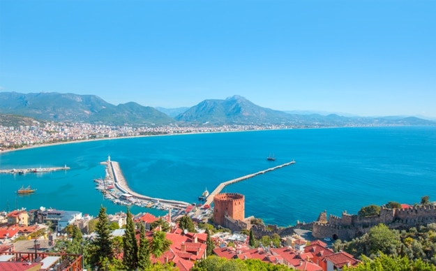 Landscape with marina and Red tower in Alanya peninsula, Antalya district, Turkey