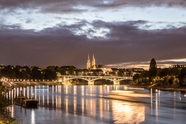Night view of the Rhine River with the illuminated Basel Minster