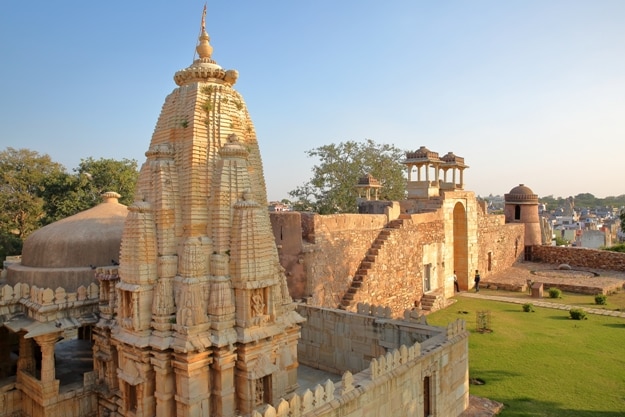 Ratan Singh Palace, located inside the fort (Garh) of Chittorgarh, with a Hindu Temple in the foreground