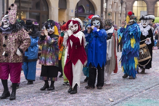 Revellers playing piccolo and snare drums and marching during a Basel Carnival procession