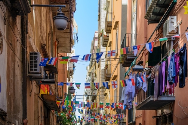Streets of Naples, June 11, 2016 in Naples, Italy. Many international small flags hanging from ropes along streets