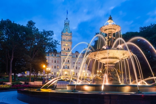 The Quebec Parliament Building and the Fontaine de Tourny at twilight in Quebec City, Quebec, Canada