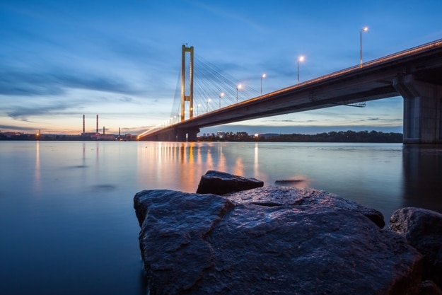 The South bridge at night, Kiev, Ukraine. Bridge at sunset across the Dnieper River. Kiev bridge against the backdrop of a beautiful sunset in Kiev. Bridge in evening sunshine