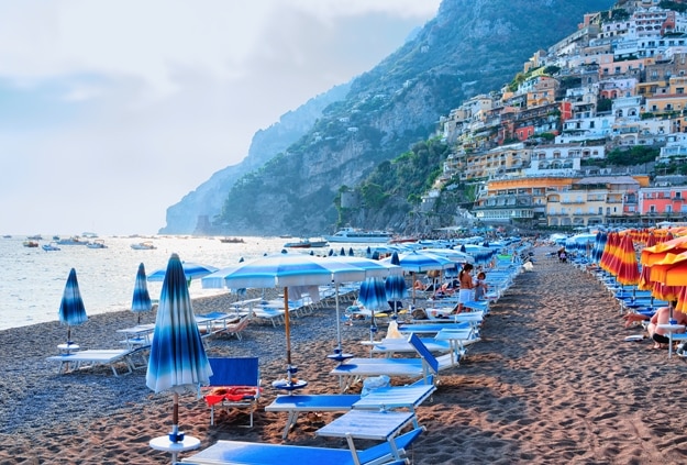 Beach with umbrellas in Positano town and Tyrrhenian sea, Amalfi coast