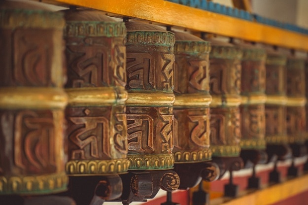 Tibetan metal prayer wheels with mantras at Manali