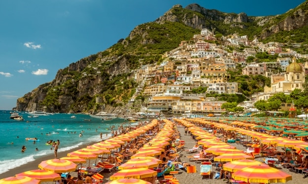 Tourists relaxing on a beach in Positano, Italy