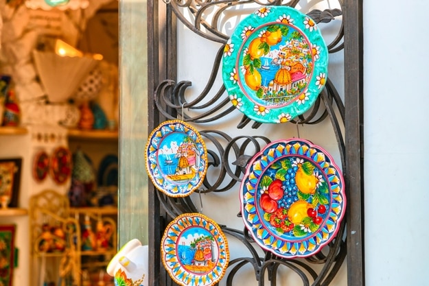 Traditional colorful ceramics plates made of clay on display in Positano town, Amalfi coast, Italy
