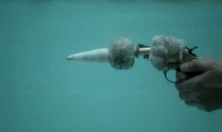 Shooting a gun underwater has never looked this cool