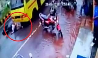 Caught on Camera: CCTV captures miraculous escape of 2 after being dragged under a bus in Gwalior! (Watch Video)