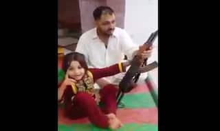 Pakistani father teaches little girl to fire AK 47 and make her threaten Narendra Modi: Watch Video