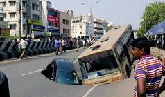 Major road-cave in Chennai's Anna Salai, car- bus trapped, no casualties reported