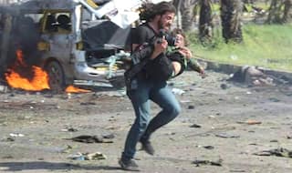 Photographer Abd Alkader Habak drops camera to help Syrian children injured in bombing; heartbreaking war photo goes viral