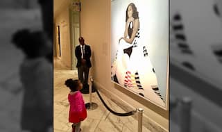 This Little Girl's Photo of Looking up to Michelle Obama's Portrait is Going Viral for Providing Inspiration