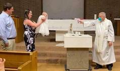Priest Practices Social Distancing by Squirting Holy Water on Baby With Toy Gun During Baptism