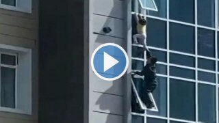 Viral Video: Man Risks His Life To Save A Child Dangling From 8th Floor, Hailed As a Hero | Watch