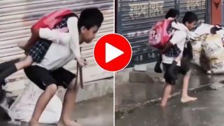 Viral Video: Sweet Brother Carries Little Sister on Back to Walk Through Waterlogged Road. Watch