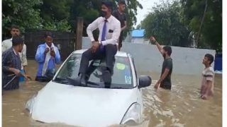 Gurugram Rains: Man Swims in Heavily Waterlogged Road in Subhash Chowk, Another Sits on Roof of Car | Videos