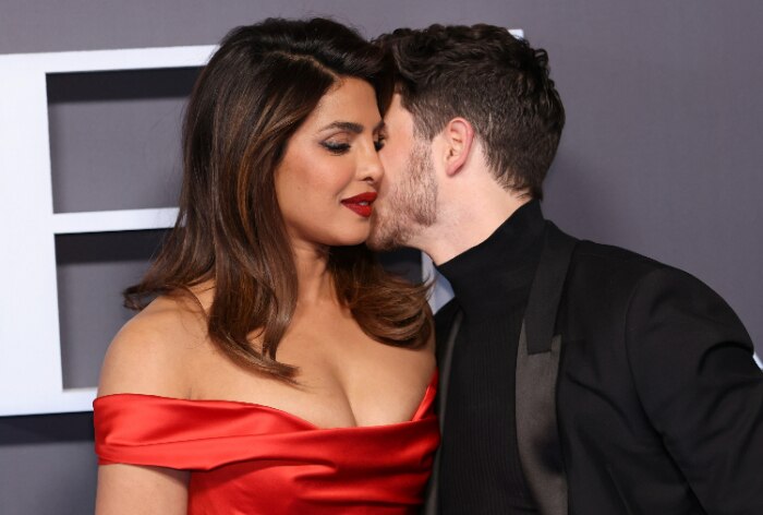 red dress nick jonas Nick Jonas Cheers For Wife Priyanka Chopra And Her Red Dress at Citadel Premiere