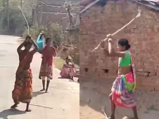 Women Fight Video: एक दूसरे को दूर से ही लाठी मारने लगीं महिलाएं, गजब की लड़ाई देख हिल गए लोग | देखें वीडियो