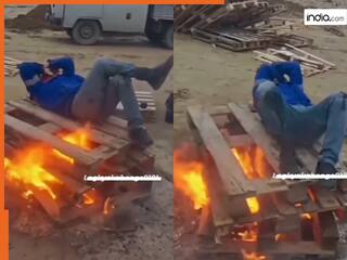 Viral Video: ठंड लगी तो सीधा आग पर लेट गया बंदा, आगे जो दिखा होश ही उड़ जाएंगे | देखें वीडियो