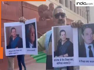 संसद परिसर में लहराया सोनिया गांधी और सोरोस का पोस्टर, गिरिराज सिंह ने पूछा- रिश्ता क्या कहलाता है?