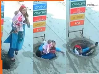 Viral Video Today: फोन पर बात करते-करते मेनहोल में समा गई महिला, बच्चा भी था गोद में | हिला देगा वीडियो