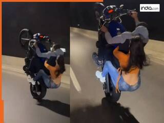 Couple Bike Stunt Video: बाइक स्टंट का ऐसा नजारा पहले कभी नहीं देखा, लड़की की हिम्मत देख हर कोई हैरान | देखें वीडियो