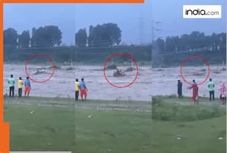Men waiting for help, swept away by river in Dehradun; video goes viral | WATCH