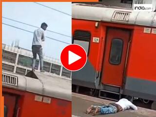 Viral Video: 'रेल से मजाक करना पड़ा भारी', ट्रेन की छत से धराम से गिरा शख्स, रेलवे स्टेशन पर देखते रह गए लोग | देखें वीडियो